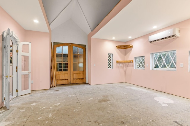 interior space featuring vaulted ceiling, french doors, and a wall mounted air conditioner