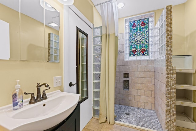 bathroom featuring sink, tile patterned floors, and tiled shower