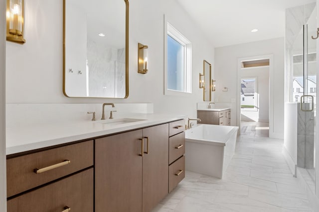 bathroom featuring separate shower and tub and vanity