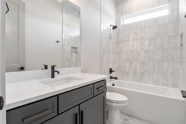 full bathroom with toilet, tiled shower / bath combo, and vanity