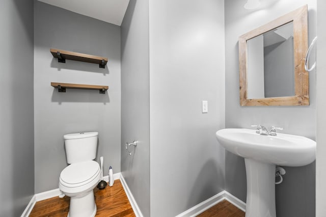 bathroom featuring toilet and wood-type flooring