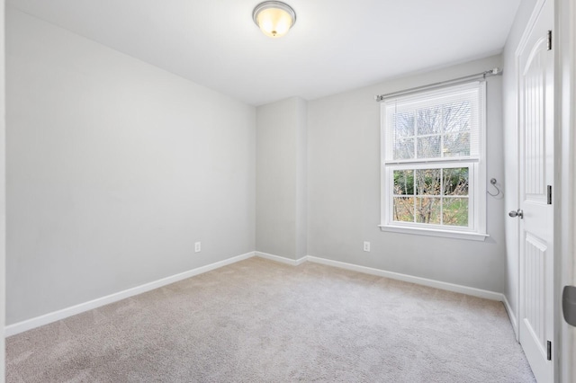 spare room with light colored carpet