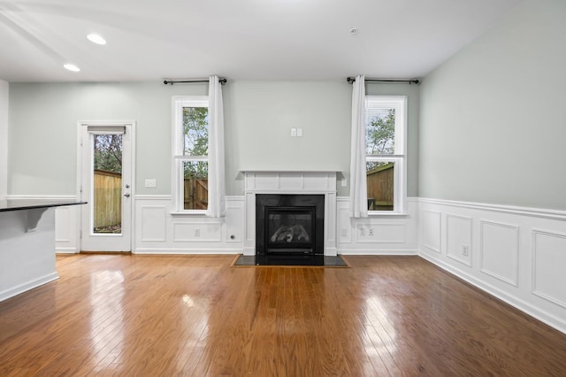 unfurnished living room featuring a healthy amount of sunlight and wood-type flooring