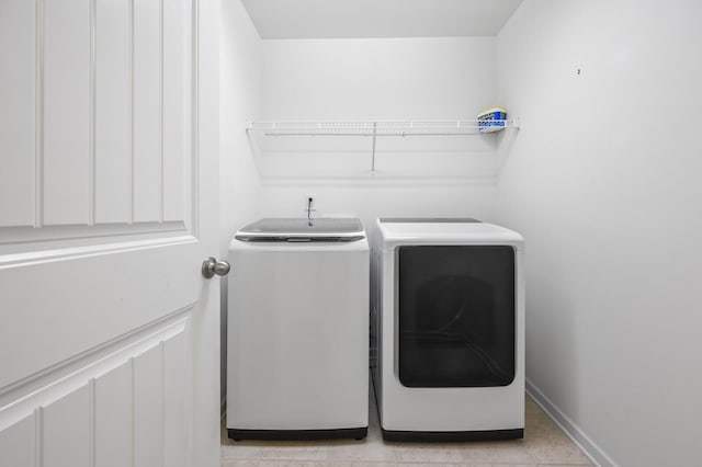 laundry area featuring washing machine and clothes dryer