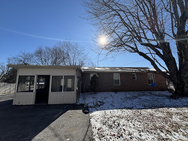 view of front of house with a sunroom