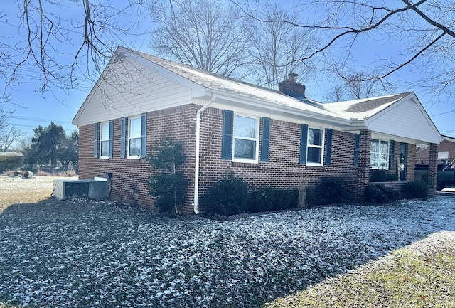 view of side of home with central AC unit