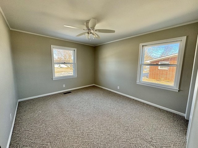 unfurnished room with carpet, baseboards, visible vents, and ornamental molding