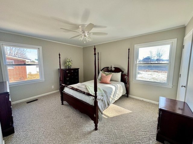 carpeted bedroom featuring ceiling fan and ornamental molding