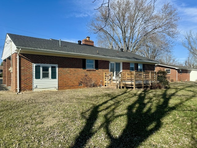 back of house with brick siding, a yard, a chimney, crawl space, and a deck