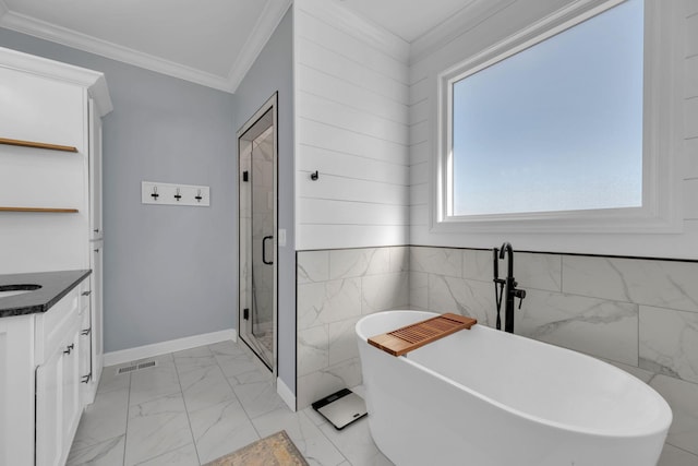 bathroom with independent shower and bath, ornamental molding, and vanity