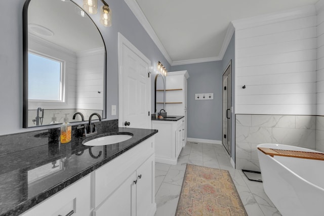 bathroom featuring crown molding, a tub to relax in, and vanity