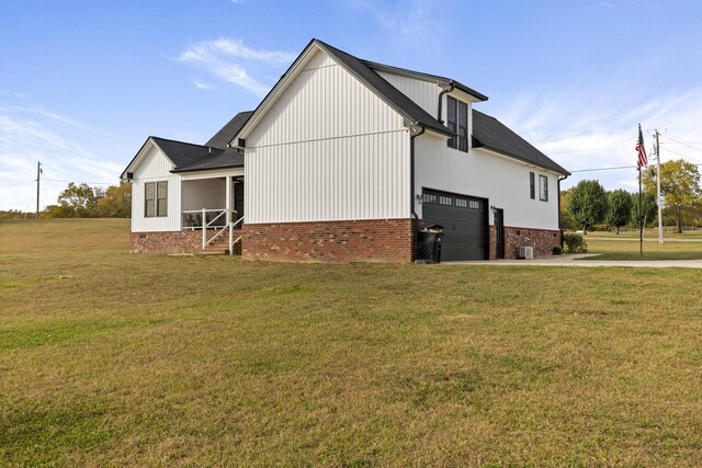 view of home's exterior with a garage, central AC unit, and a lawn