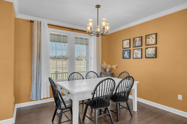 dining room featuring dark hardwood / wood-style floors, crown molding, and a notable chandelier