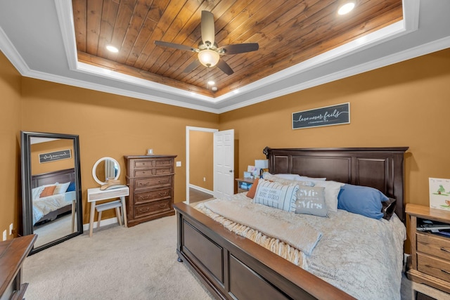 bedroom featuring ceiling fan, light carpet, wood ceiling, and a tray ceiling