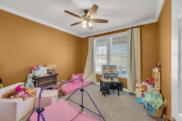 recreation room featuring ceiling fan, carpet, and ornamental molding