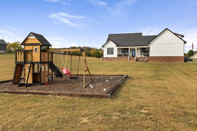 view of play area featuring a porch and a lawn