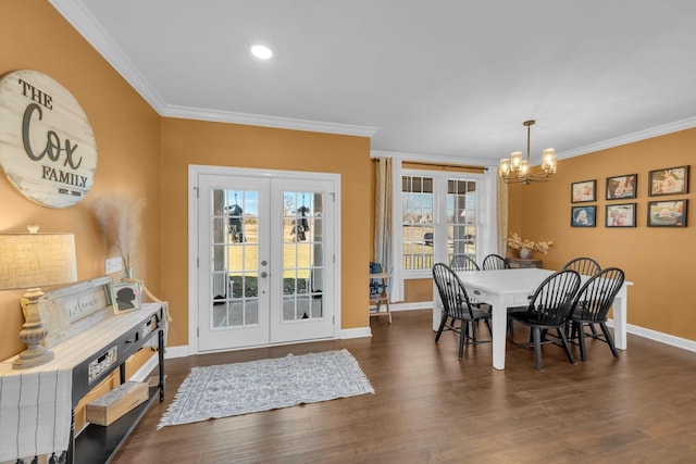 dining space featuring dark hardwood / wood-style floors, a notable chandelier, ornamental molding, and french doors