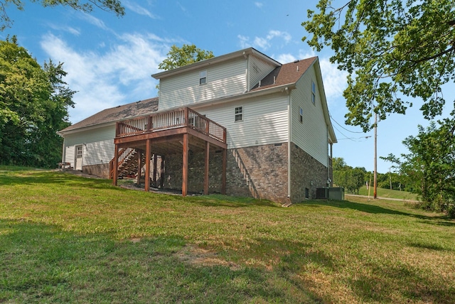 back of property with a lawn and a wooden deck