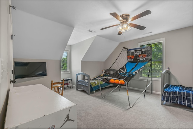 bedroom featuring vaulted ceiling, ceiling fan, carpet floors, and multiple windows