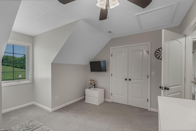 additional living space with light carpet, ceiling fan, and lofted ceiling