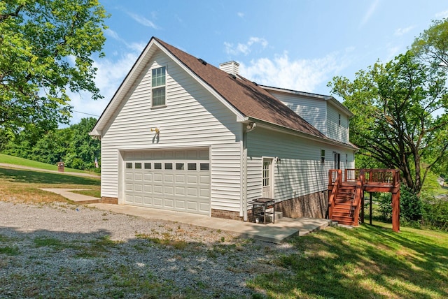 view of side of property featuring a deck and a yard