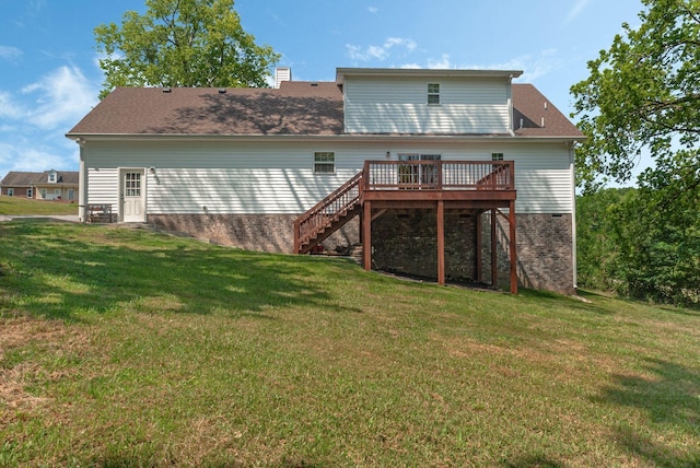 back of property with a deck and a lawn