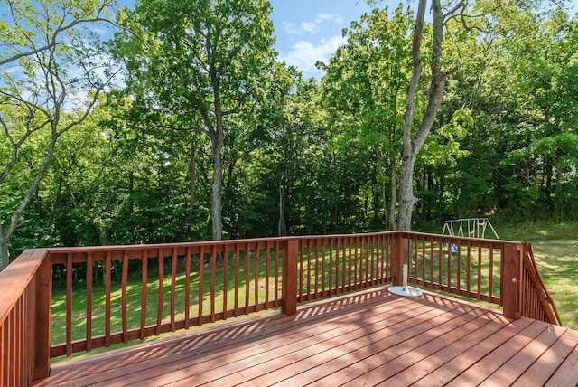 wooden deck featuring a yard and a playground