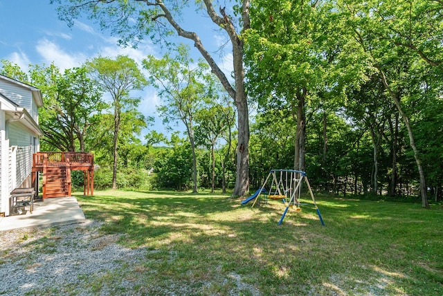 view of yard with a playground and a wooden deck