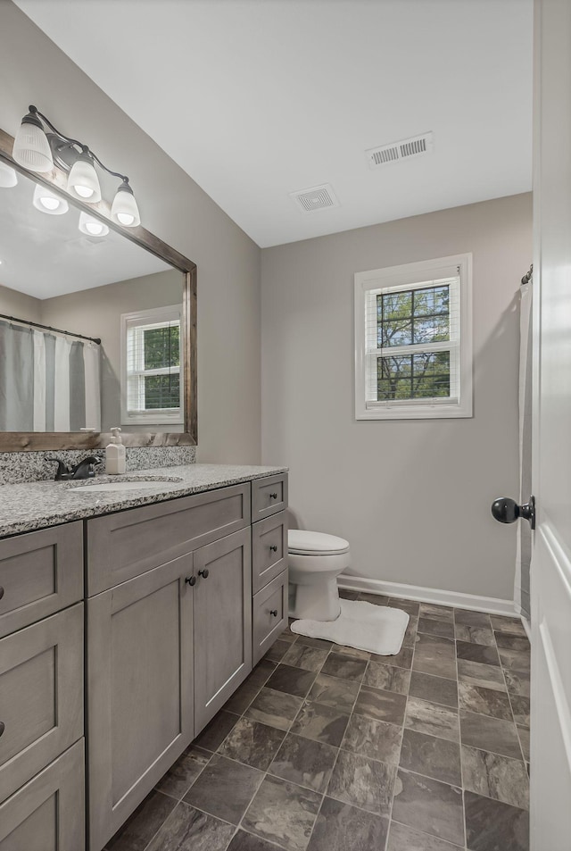 bathroom featuring toilet and vanity