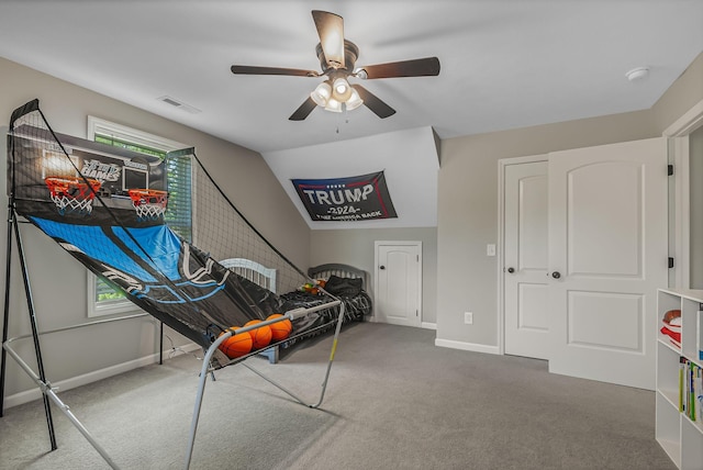 rec room with ceiling fan, vaulted ceiling, and carpet flooring