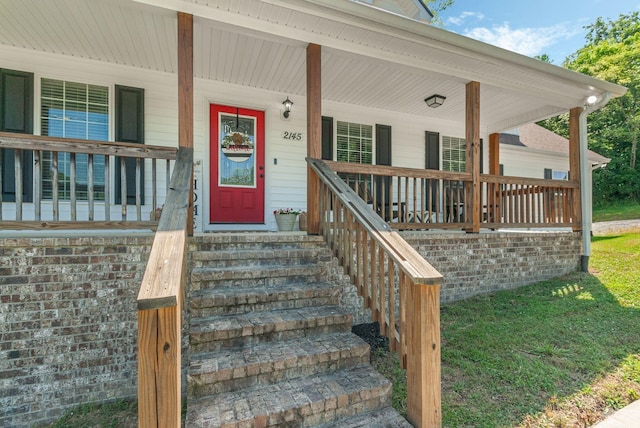 view of exterior entry with covered porch