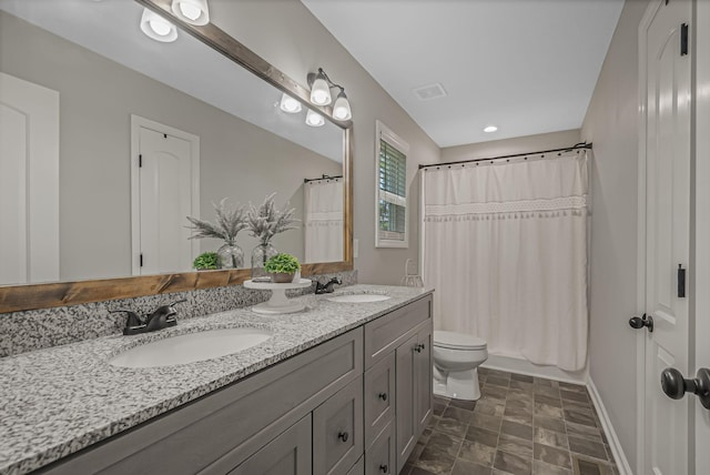 full bathroom featuring toilet, vanity, and shower / bath combo with shower curtain