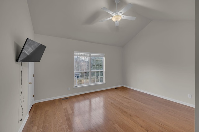 unfurnished bedroom with light wood-type flooring, ceiling fan, and vaulted ceiling