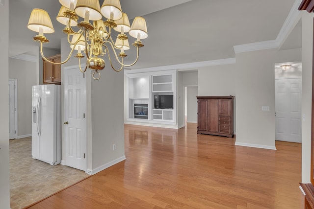 kitchen with light hardwood / wood-style floors, white fridge with ice dispenser, a chandelier, and ornamental molding