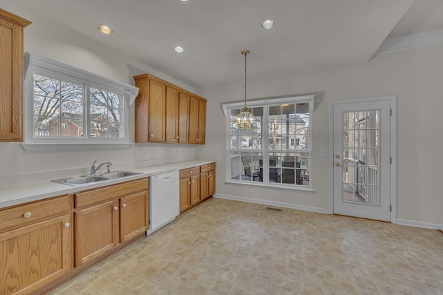 kitchen with sink, pendant lighting, dishwasher, and a notable chandelier