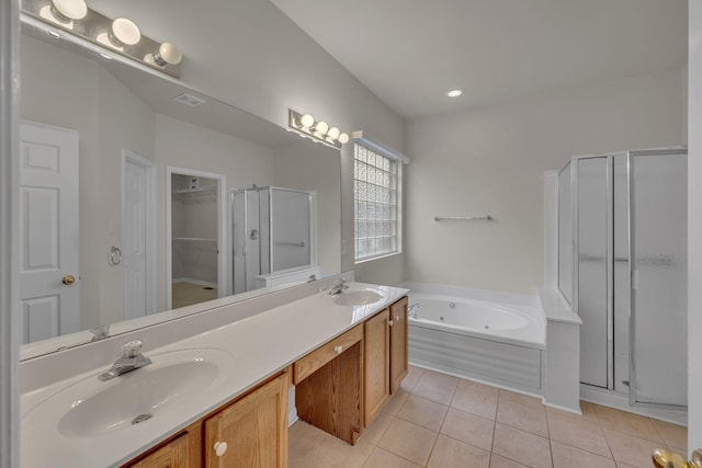 bathroom with tile patterned flooring, shower with separate bathtub, and vanity