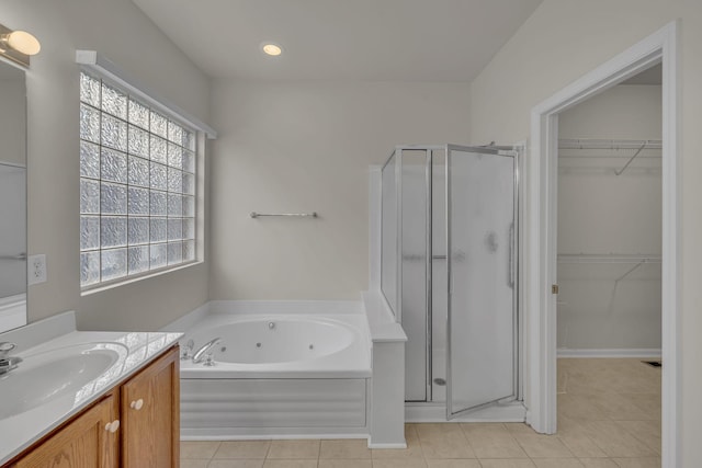 bathroom with tile patterned floors, separate shower and tub, and vanity