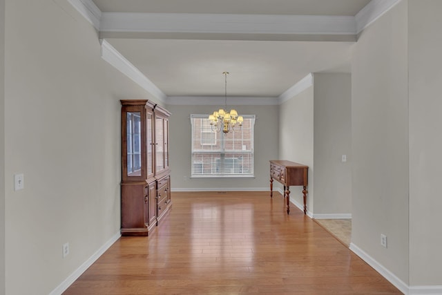 unfurnished dining area with crown molding, an inviting chandelier, and light hardwood / wood-style floors