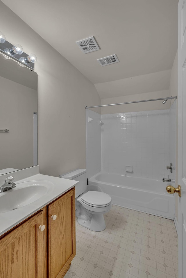 full bathroom featuring vaulted ceiling, toilet,  shower combination, and vanity