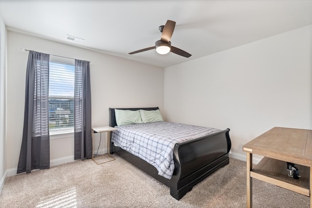 carpeted bedroom featuring ceiling fan and multiple windows