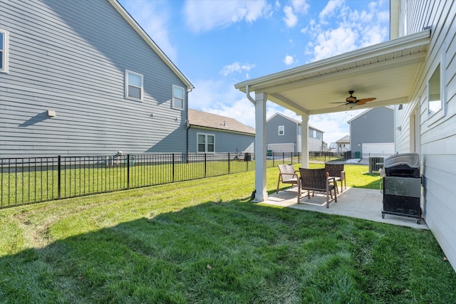 view of yard with ceiling fan, cooling unit, and a patio area