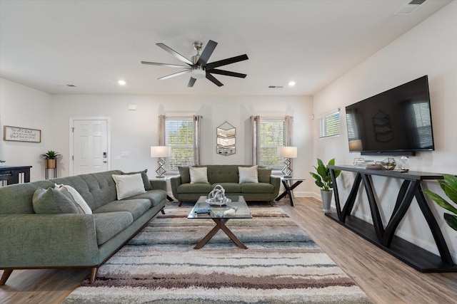 living room featuring ceiling fan and light hardwood / wood-style floors