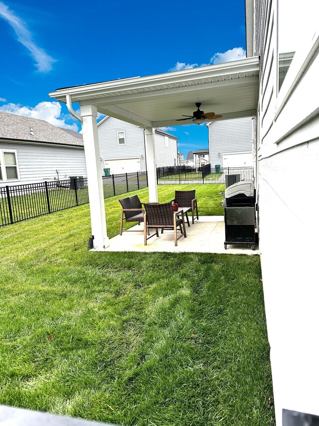 view of yard with a patio area and ceiling fan