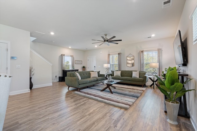 living room featuring ceiling fan and light hardwood / wood-style floors