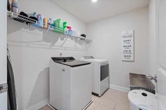 laundry room with light tile patterned floors and independent washer and dryer