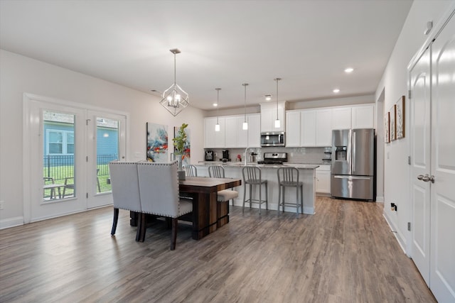 dining area featuring hardwood / wood-style floors and a chandelier