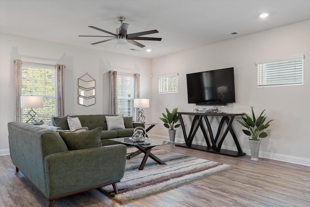 living room with ceiling fan, a wealth of natural light, and hardwood / wood-style floors