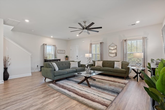 living room with ceiling fan and light wood-type flooring