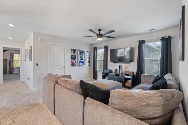 living room featuring ceiling fan and light colored carpet