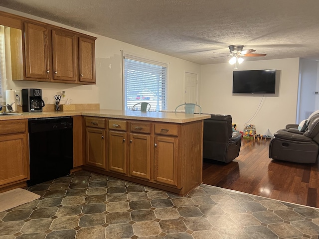 kitchen featuring ceiling fan, dishwasher, dark hardwood / wood-style floors, kitchen peninsula, and a textured ceiling